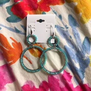 A teal pair of earrings